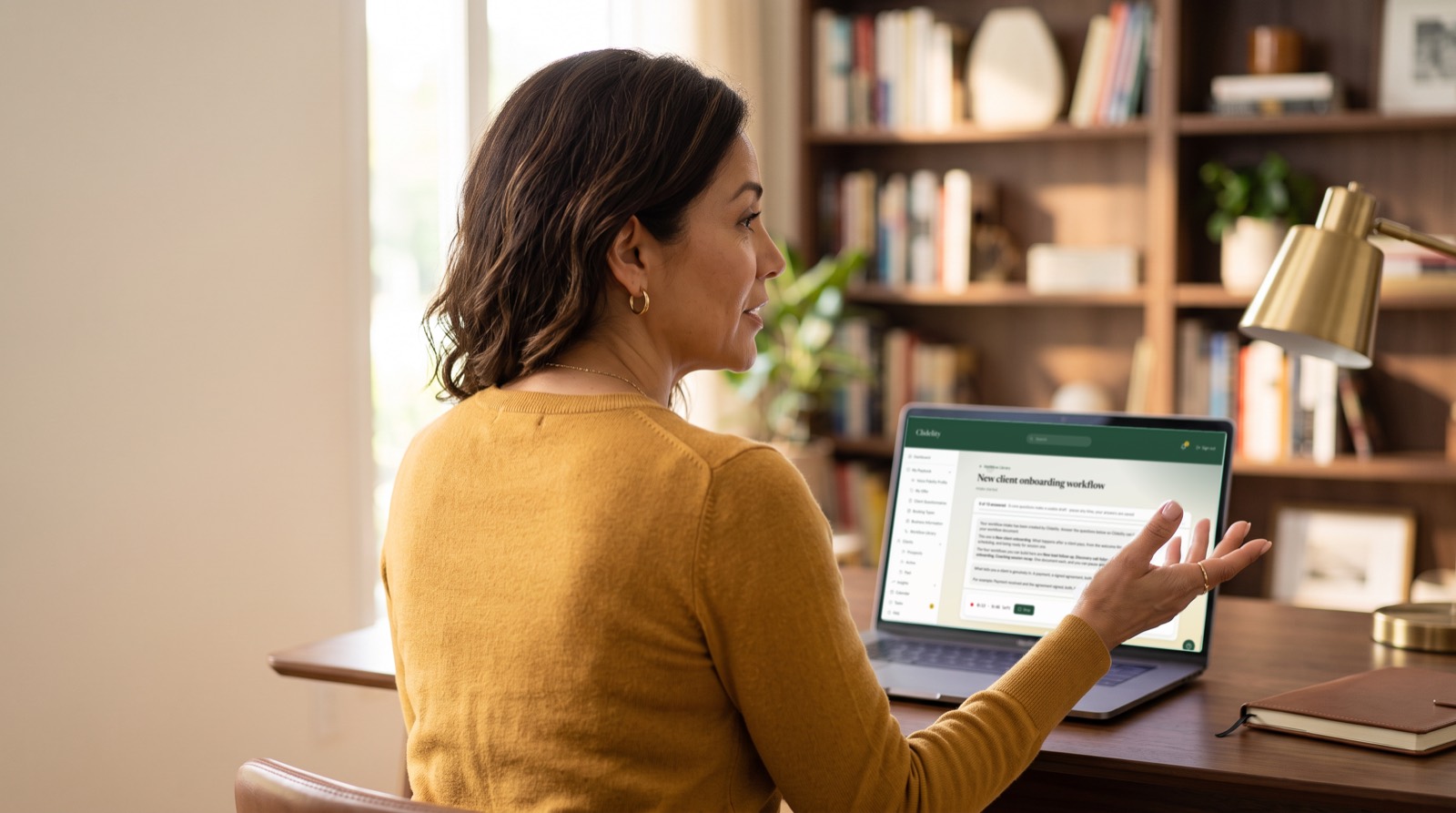 A coach building a workflow by talking it through with Clidelity on her laptop.